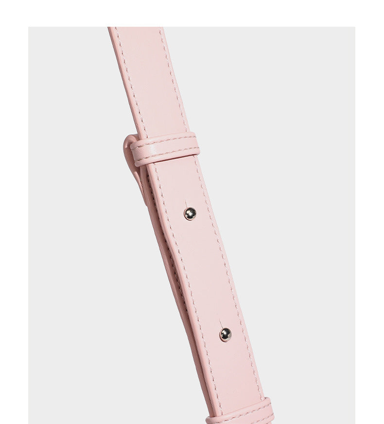Smooth leather-look crescent shoulder bag with front zip pocket, side flap pockets, adjustable strap, and silver-tone, detail