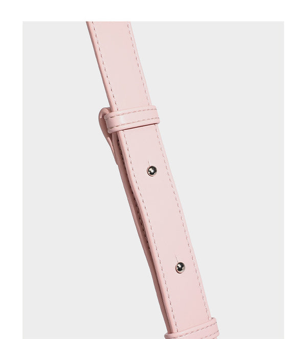 Smooth leather-look crescent shoulder bag with front zip pocket, side flap pockets, adjustable strap, and silver-tone, detail