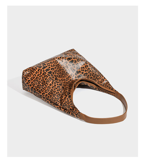Glossy leopard-print slouchy shoulder bag with long strap and detachable tan zip pouch, detail view 11