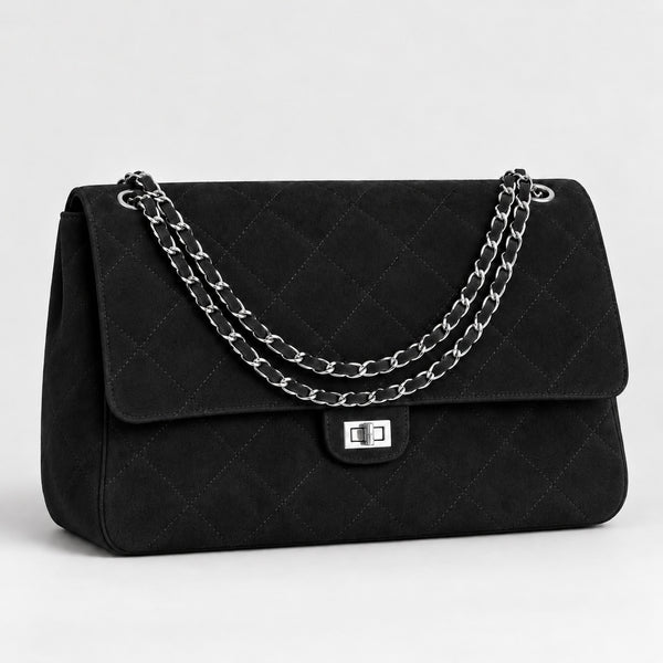Quilted diamond-stitch flap shoulder bag with double silver chain strap and turn-lock closure in suede-look finish, detail