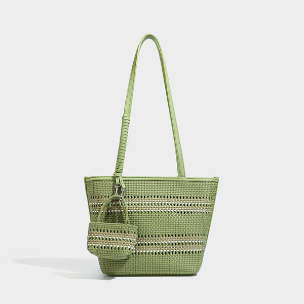 Large structured woven tote bag with striped basket-weave finish, long shoulder straps, and detachable mini pouch charm
