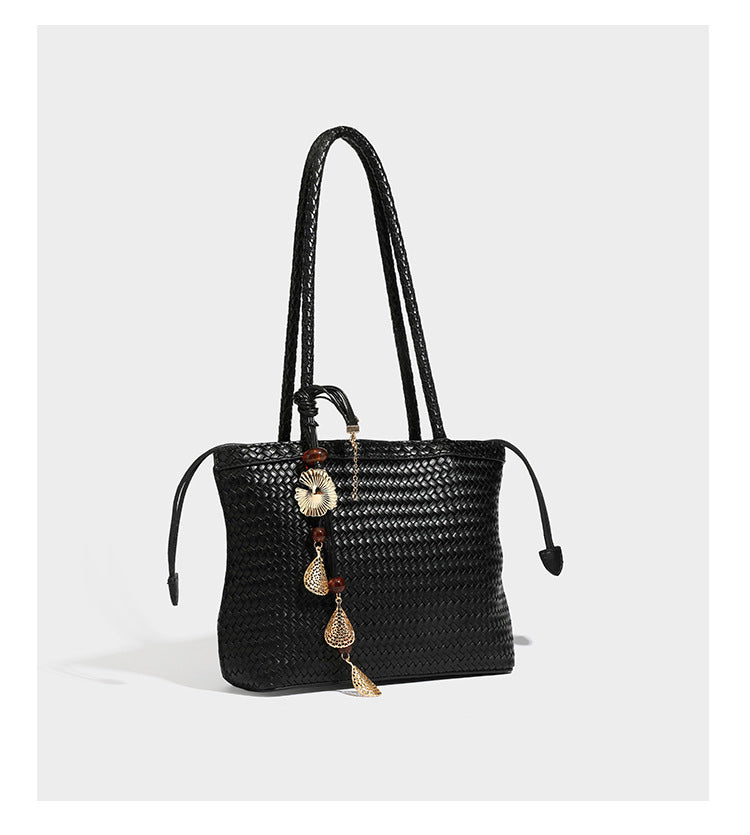 Structured woven leather-look tote bag in dark brown with long shoulder straps, side drawstring ties, and gold filigree