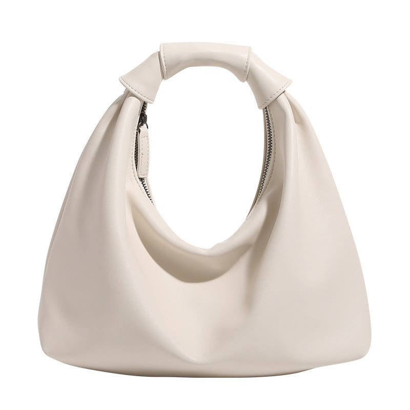 Slouchy leather-look hobo bag with knotted loop handle and top zipper closure, detail view 5