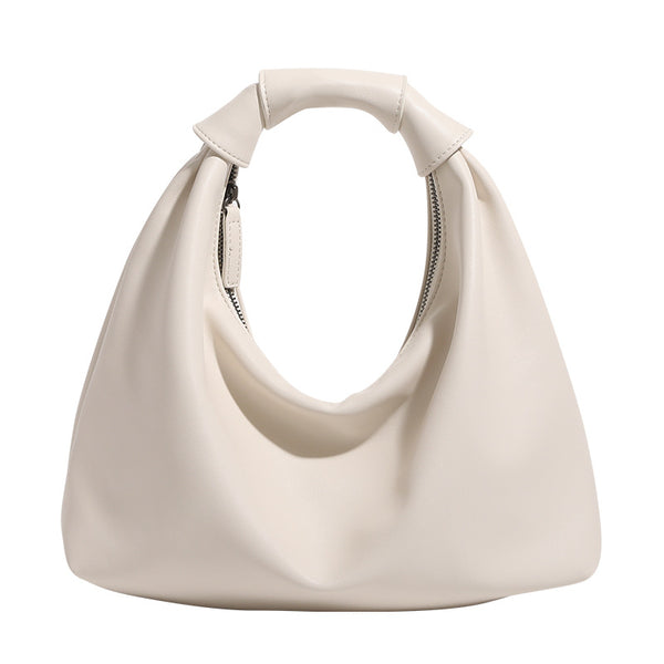 Slouchy leather-look hobo bag with knotted loop handle and top zipper closure, detail view 5