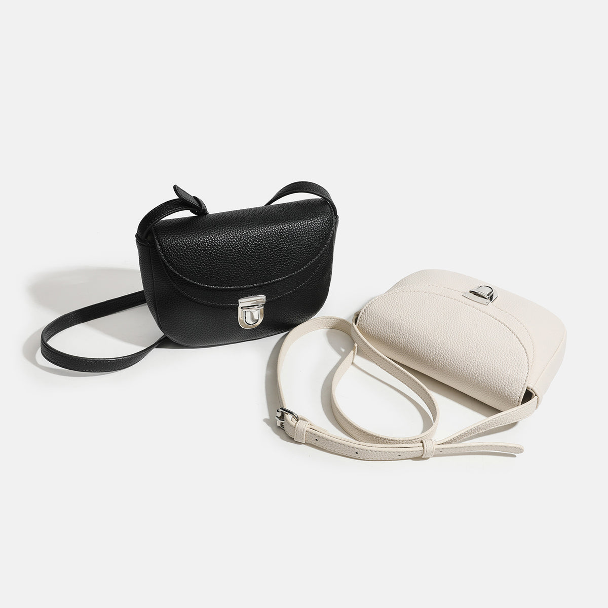 Mini pebbled saddle crossbody bag with silver-tone turn-lock flap closure and adjustable shoulder strap, detail view 2