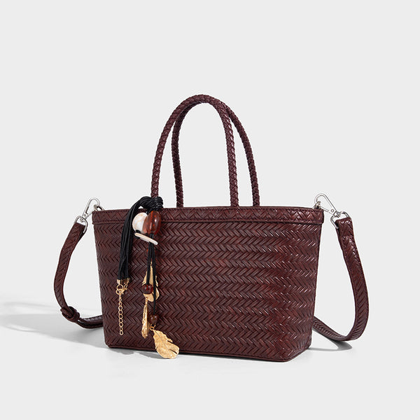 Structured chevron woven leather-look tote bag with braided top handles, gold feather charm, and adjustable shoulder strap