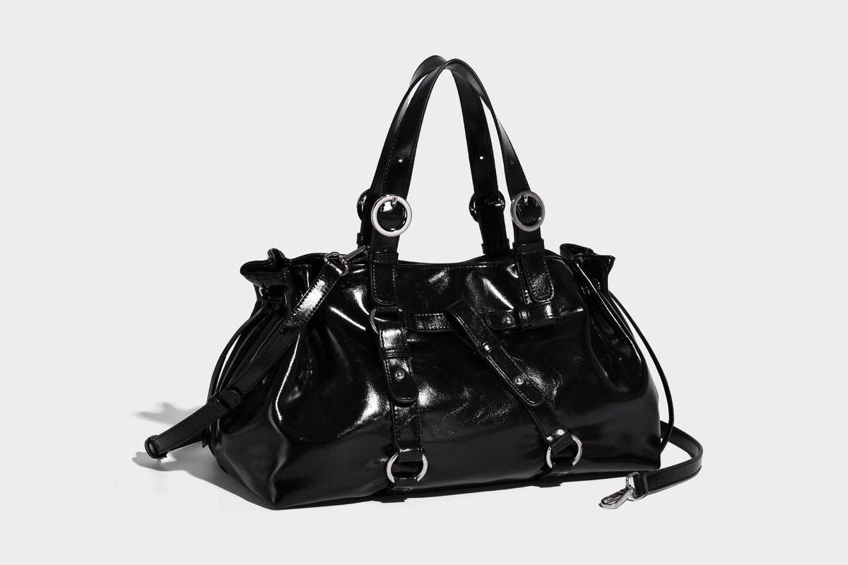 Glossy patent-look slouchy tote bag with ruched drawstring sides, dual top handles, silver ring hardware, and detachable