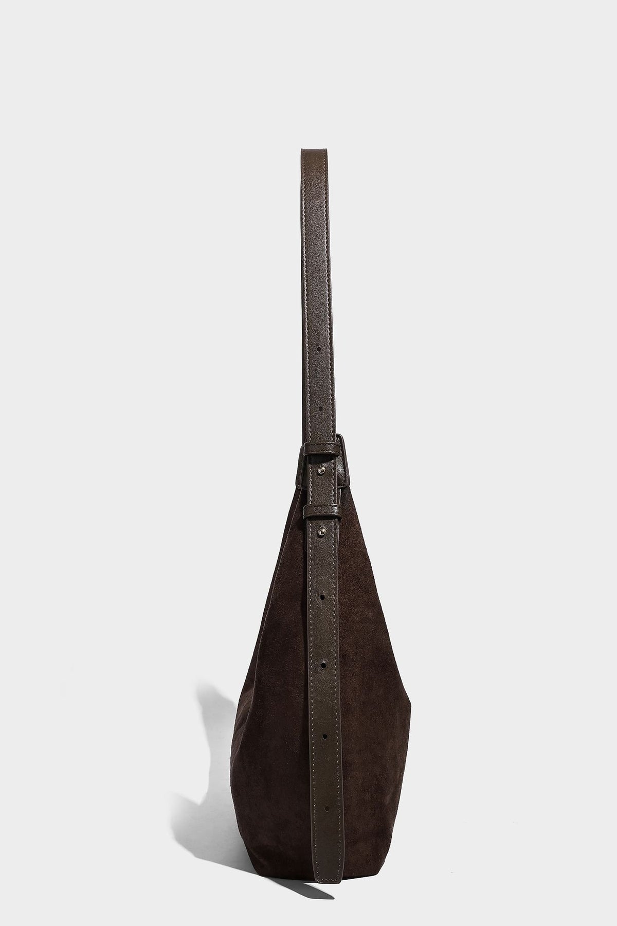 Slouchy crescent hobo shoulder bag in dark chocolate matte suede-look finish with adjustable strap and twin-pull top zip