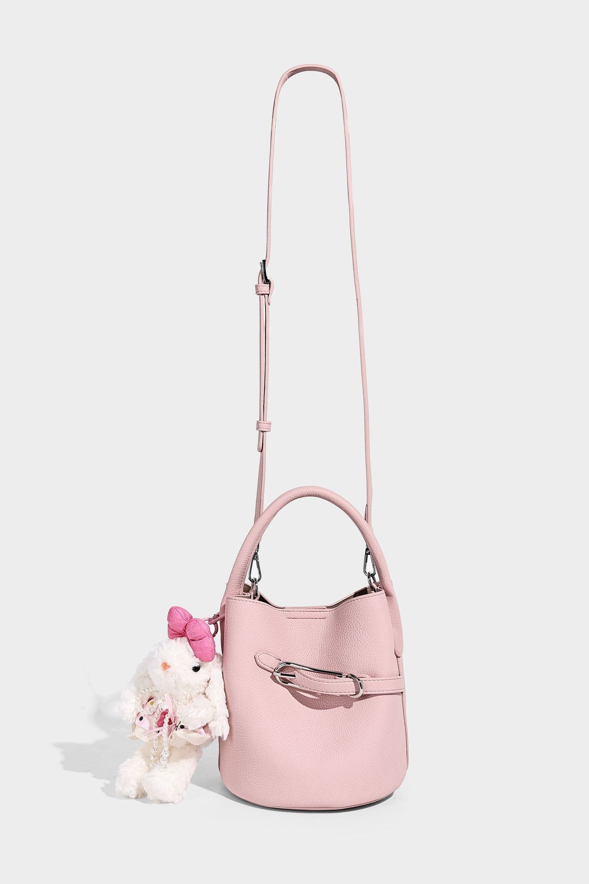Mini pebbled leather-look bucket bag with front buckle strap, silver-tone hardware, top handle, and detachable shoulder