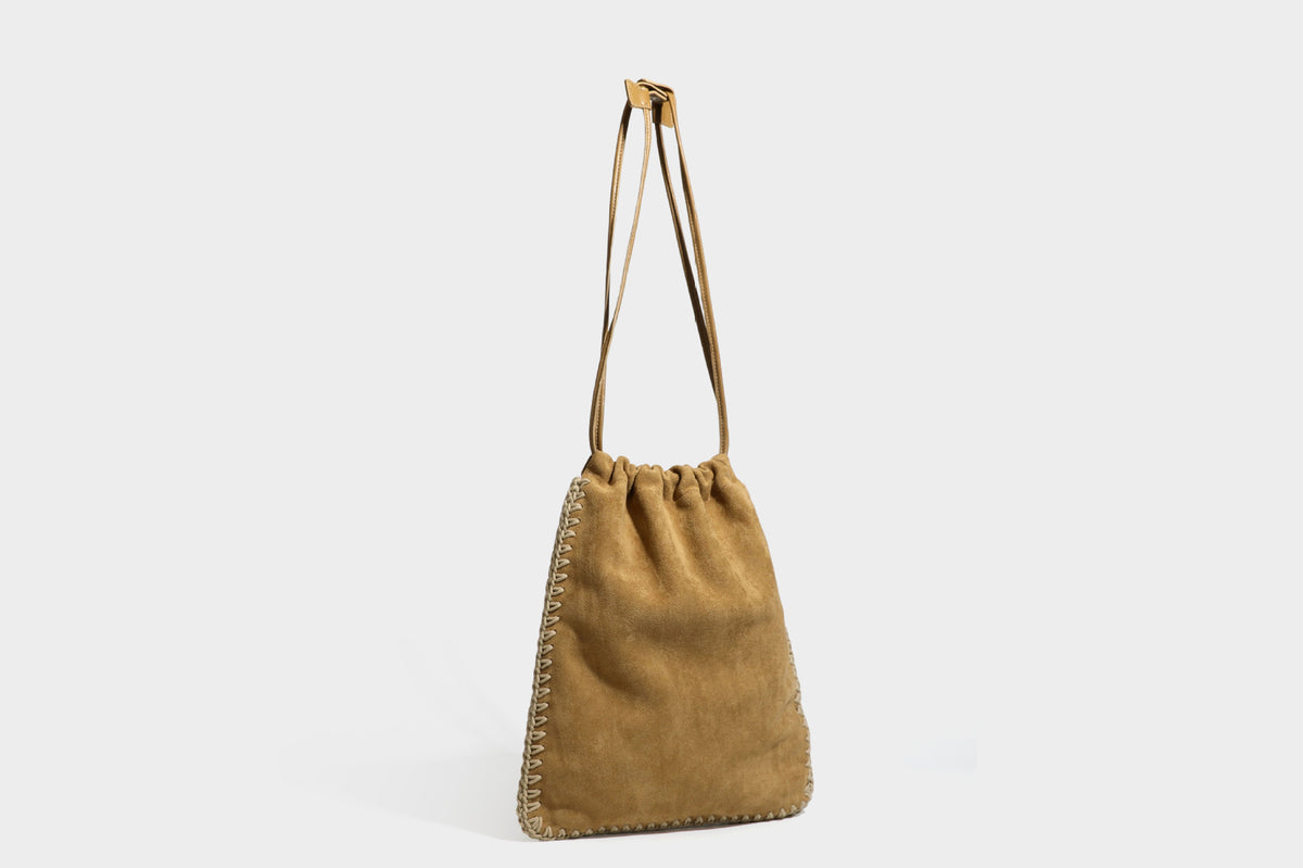 Matte suede-look drawstring bucket bag with cream braided woven edge trim and slim adjustable leather-look shoulder strap