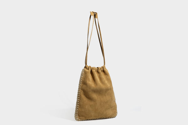 Matte suede-look drawstring bucket bag with cream braided woven edge trim and slim adjustable leather-look shoulder strap