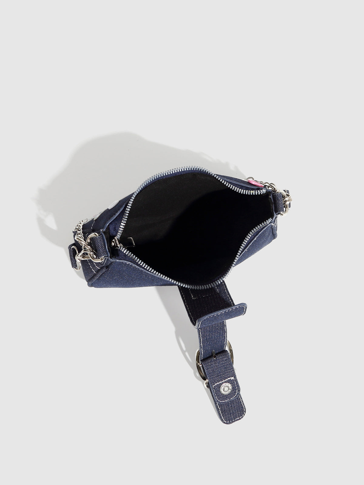 Dark navy denim-look shoulder bag with light blue and pink star appliqués, silver-tone buckle, chain strap, and short top