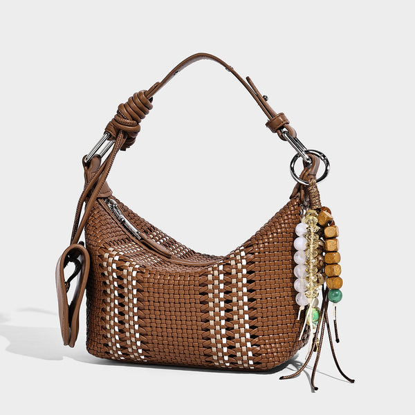 Small woven crescent shoulder bag with leather-look trim, zip closure, silver-tone ring hardware, and beaded tassel charm