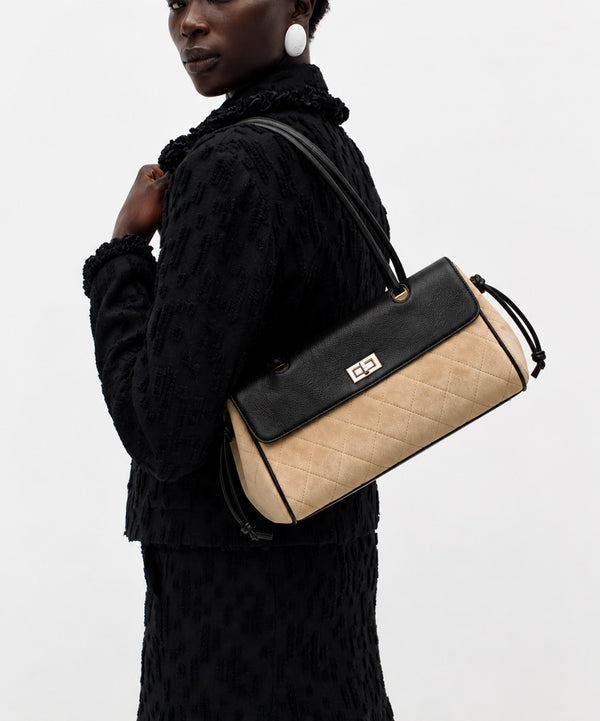 Compact two-tone quilted shoulder bag with black leather-look flap, silver turn-lock clasp, diamond-quilted body, side