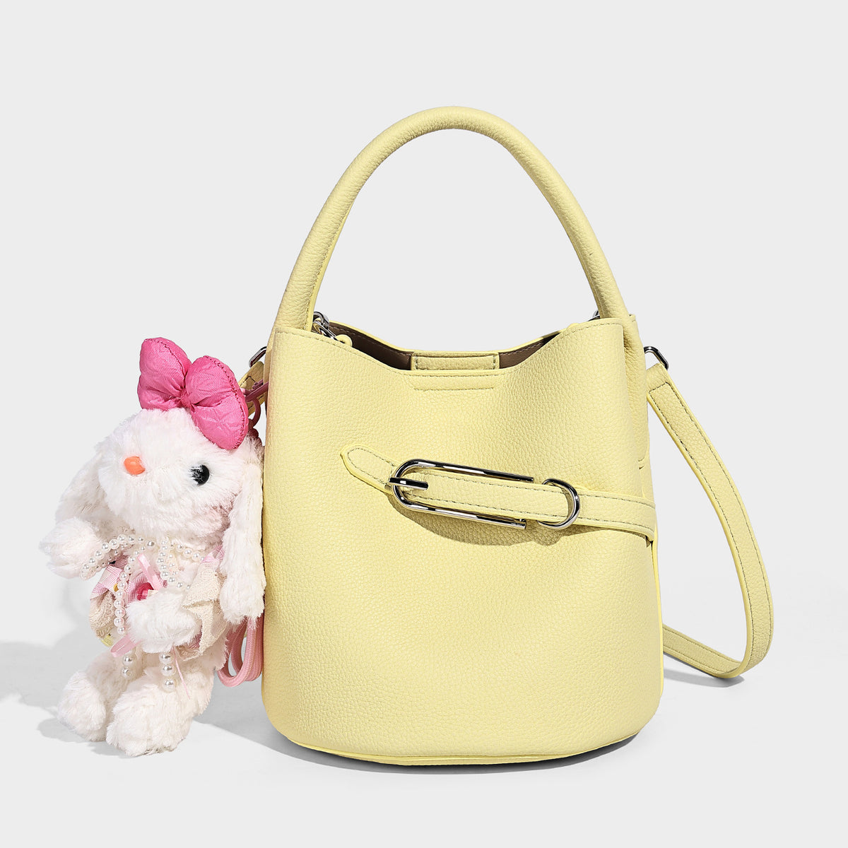 Mini pebbled leather-look bucket bag with front buckle strap, silver-tone hardware, top handle, and detachable shoulder
