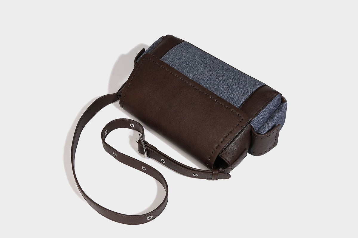 Structured flap crossbody bag in dark brown and cream color-block with white contrast stitching, adjustable shoulder strap