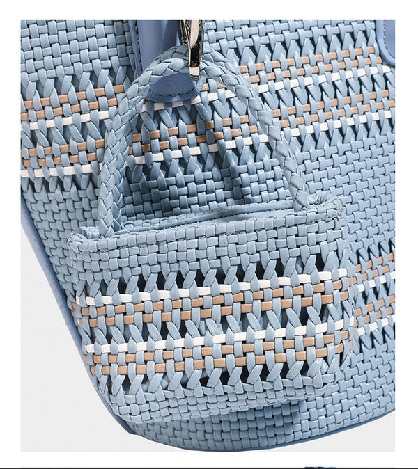 Light blue open-weave woven bucket tote bag with long braided shoulder straps, drawstring side ties, and attached mini pouch