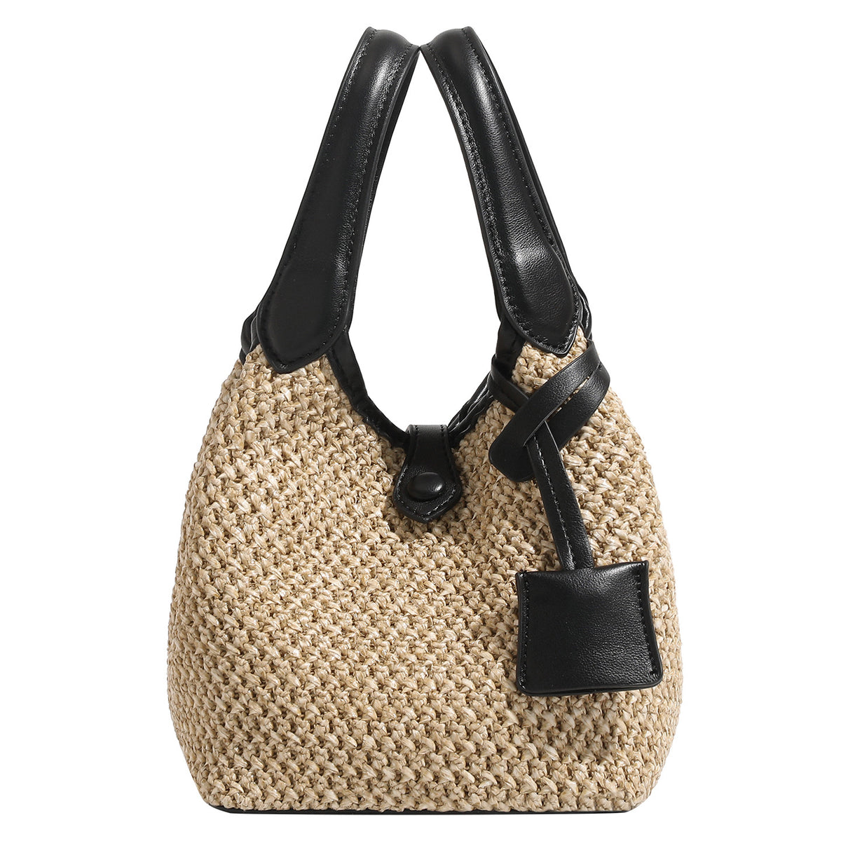 Woven beige straw bucket bag with black leather-look trim, dual top handles, detachable shoulder strap, and front snap