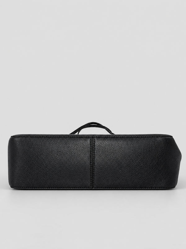 Structured black flap shoulder bag with pebbled texture, silver-tone turn-lock closure, and adjustable single shoulder strap