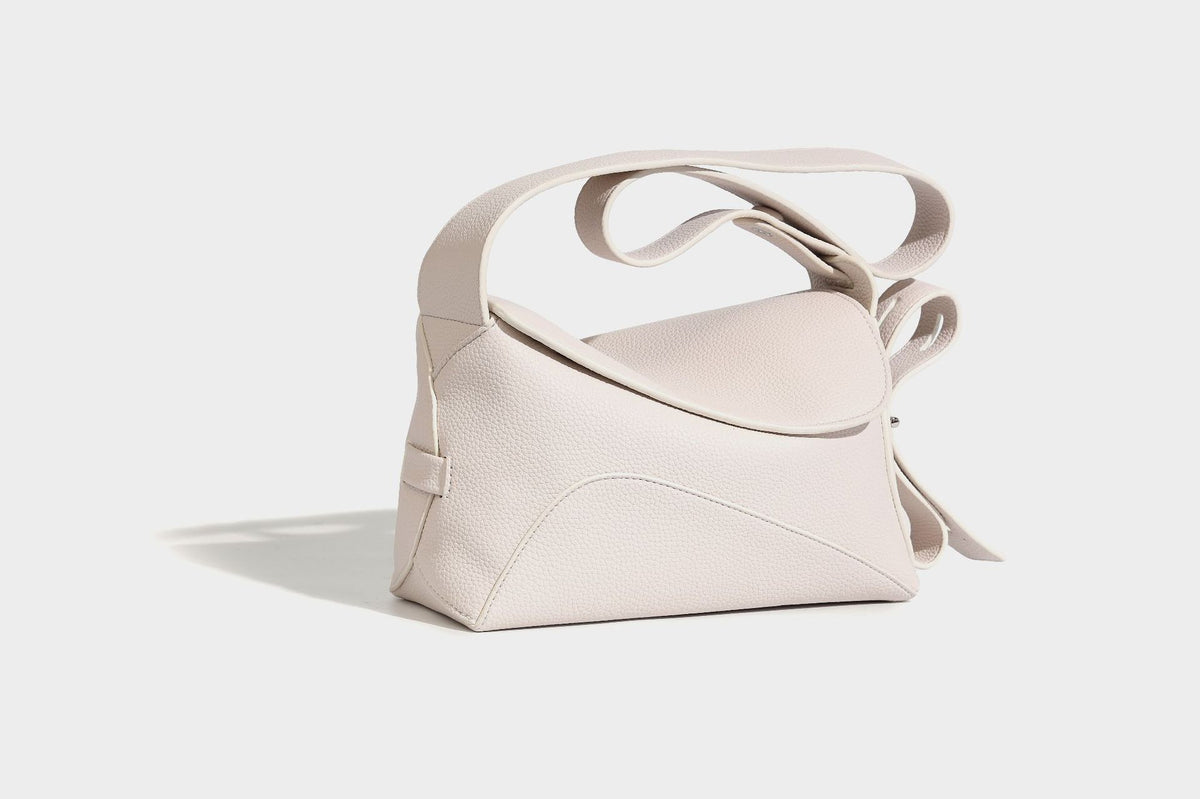 Structured curved-flap pebbled PU shoulder bag with sculptural loop strap detail, detail view 8