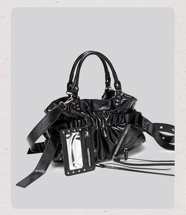 Black glossy ruched convertible tote bag with silver-tone rivets, detachable wide shoulder strap, external zip pouch, and