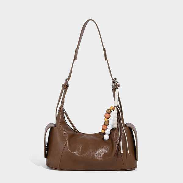 Soft pebbled leather-look hobo shoulder bag with zip top closure, side flap pockets, and silver-tone hardware, detail view 7