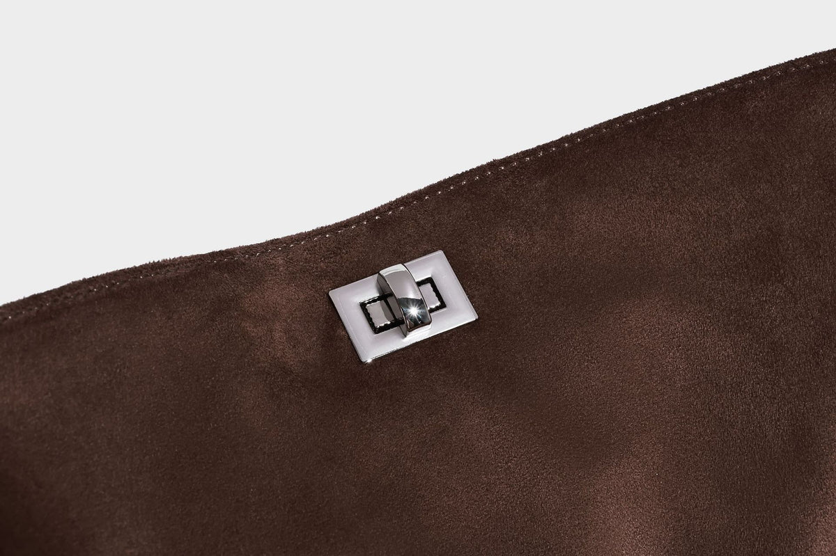 Dark brown slouchy hobo bag with matte suede-look body, smooth leather-look base trim, adjustable shoulder strap, and, detail