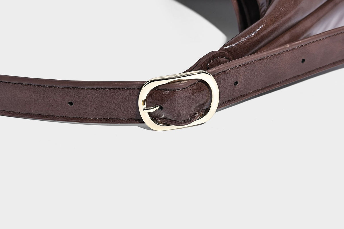 Glossy slouchy hobo shoulder bag with adjustable strap and embossed floral emblem, detail view 21