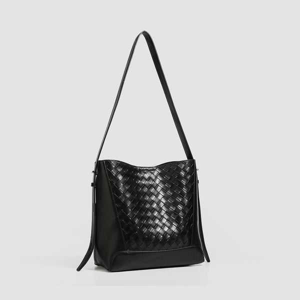 Large black bucket shoulder bag with diamond woven leather-look front panel, smooth side panels, magnetic snap closure, and