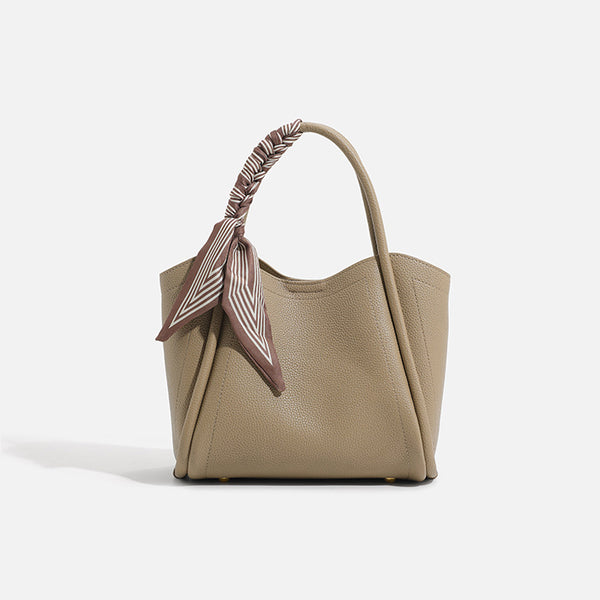 Pebbled leather-look bucket tote bag with scarf-wrapped top handle and gold-tone hardware, detail view 2