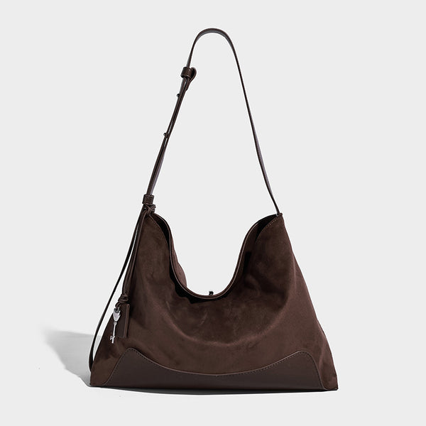 Dark brown slouchy hobo bag with matte suede-look body, smooth leather-look base trim, adjustable shoulder strap, and, detail