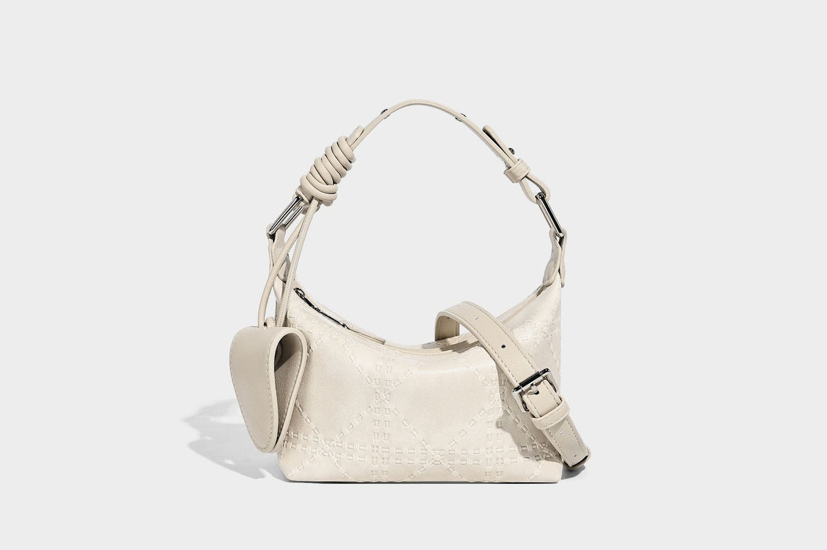 Small embossed half-moon shoulder bag with top zipper, detachable front pouch, and adjustable slim strap, detail view 11