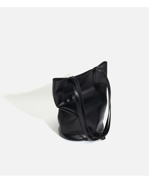 Large black smooth leather-look bucket tote bag with long shoulder straps and open top, detail view 15