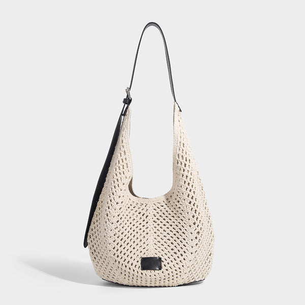 Cream openwork crochet hobo bag with black leather-look strap and trim patch accent, slouchy teardrop silhouette, front view