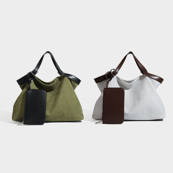 Lässig geschnittene Tote-Tasche in Olivgrün mit Canvas-Optik, schwarzen Henkeln in Lederoptik, abnehmbarer Reißverschlusstasche und silberfarbenen Beschlägen
