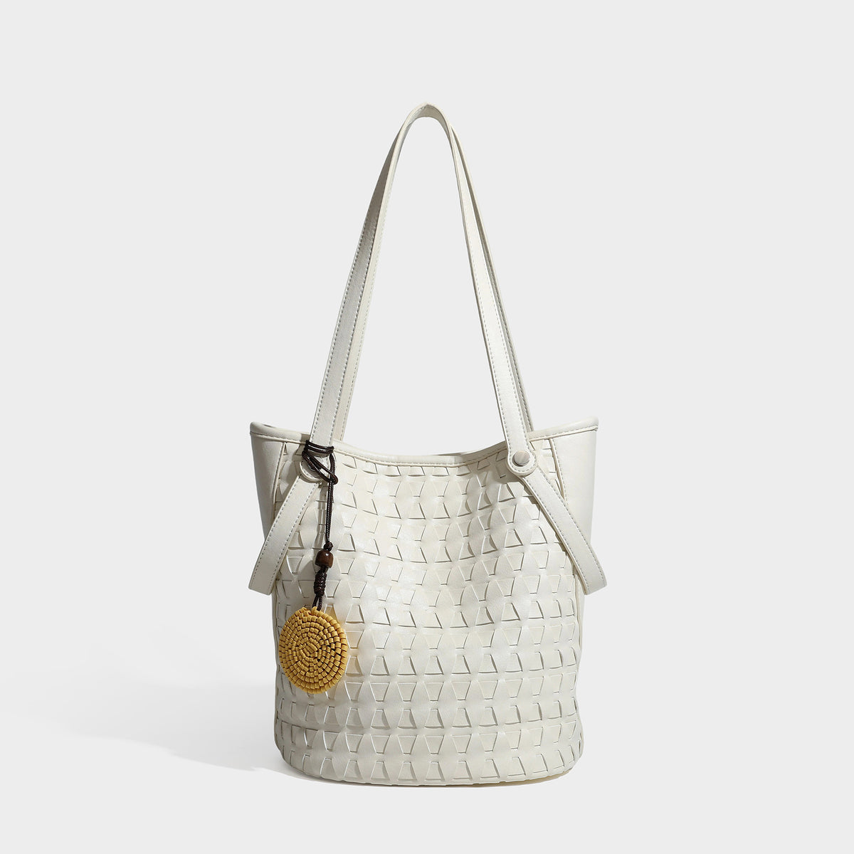 Brown embossed geometric woven leather-look bucket tote bag with dual shoulder straps, side snap hardware, and a round