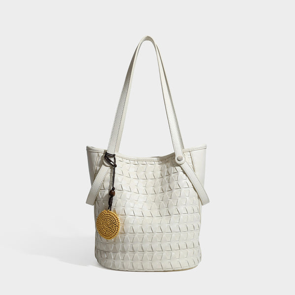 Brown embossed geometric woven leather-look bucket tote bag with dual shoulder straps, side snap hardware, and a round