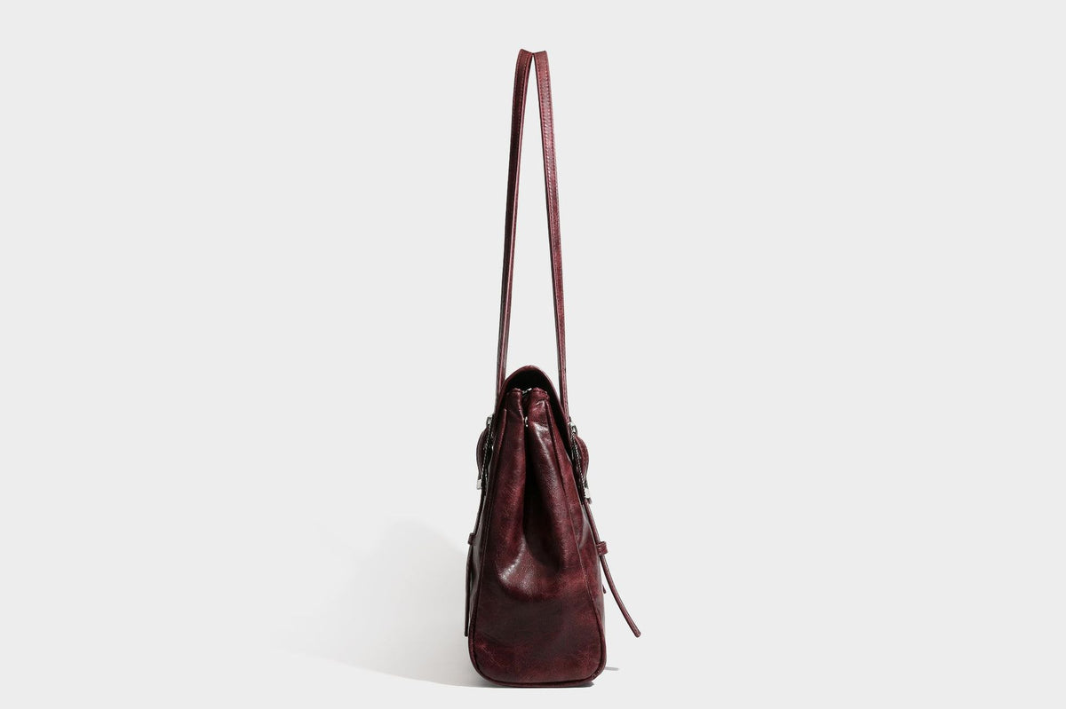 Structured flap-top shoulder tote bag in distressed leather-look finish with silver-tone buckle hardware and double shoulder