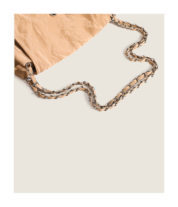 Crinkle-finish leather-look shoulder bag with woven tan-and-metal chain strap and front flap turn-lock closure, detail view 9