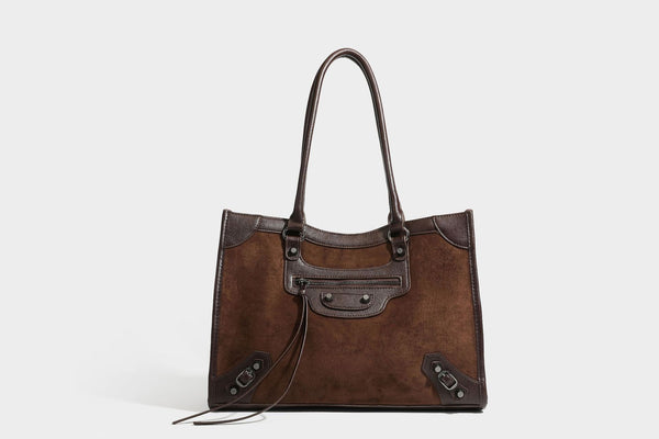 Large structured tote bag with matte suede-like body, smooth leather-look trim, front zip pocket, stud hardware, and