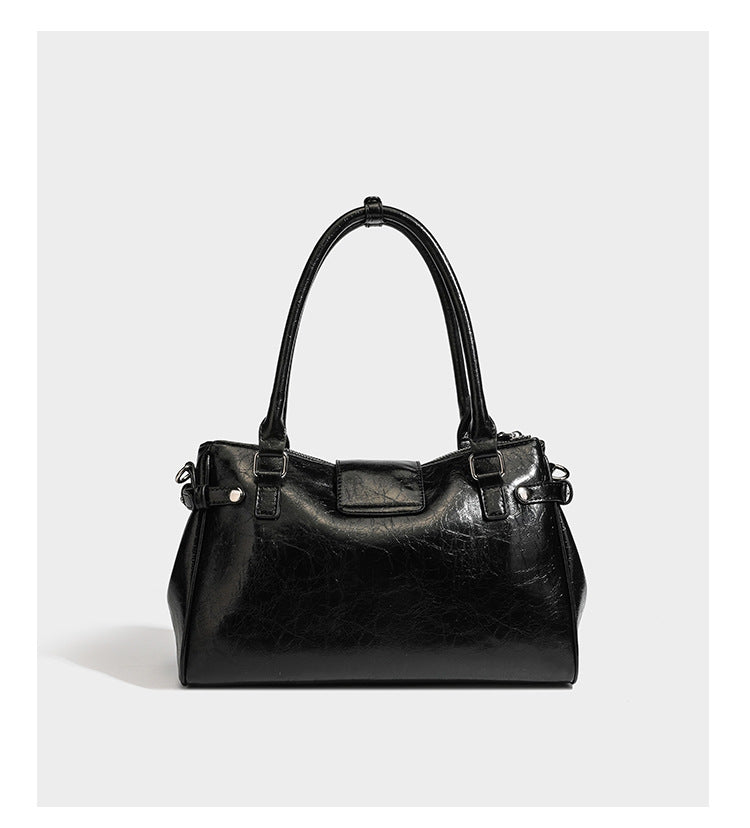 Structured glossy crinkled leather-look satchel with double top handles, front metal-plaque tab, silver-tone hardware, and