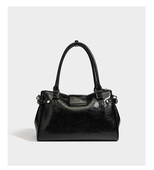 Structured glossy crinkled leather-look satchel with double top handles, front metal-plaque tab, silver-tone hardware, and