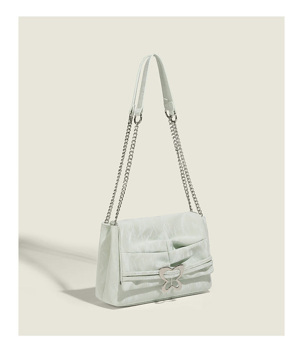 Structured rectangular chain shoulder bag with silver butterfly clasp and glossy crinkled finish, detail view 11