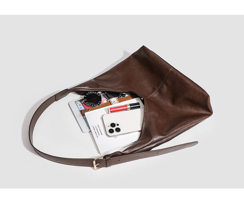Large slouchy hobo shoulder bag in smooth leather-look finish with adjustable strap and gold-tone hardware, detail view 10