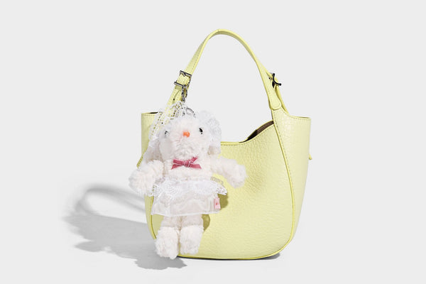 Small pebbled half-moon shoulder bag with dual top handles, detachable crossbody strap, and silver-tone hardware, detail view