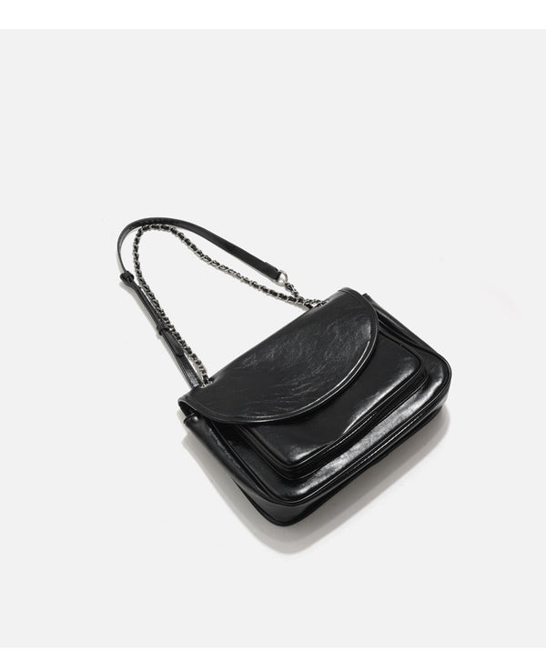 Structured glossy leather-look flap crossbody satchel with woven chain-and-leather shoulder strap, detail view 11
