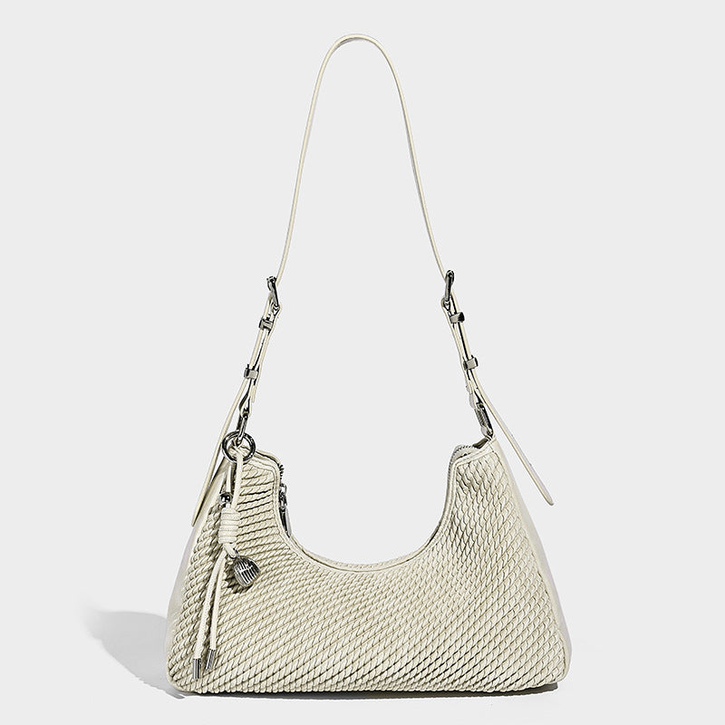Woven crescent hobo shoulder bag with smooth side panels, zip-top closure, silver-tone charm hardware, and adjustable, detail