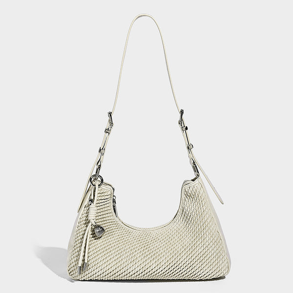 Woven crescent hobo shoulder bag with smooth side panels, zip-top closure, silver-tone charm hardware, and adjustable, detail