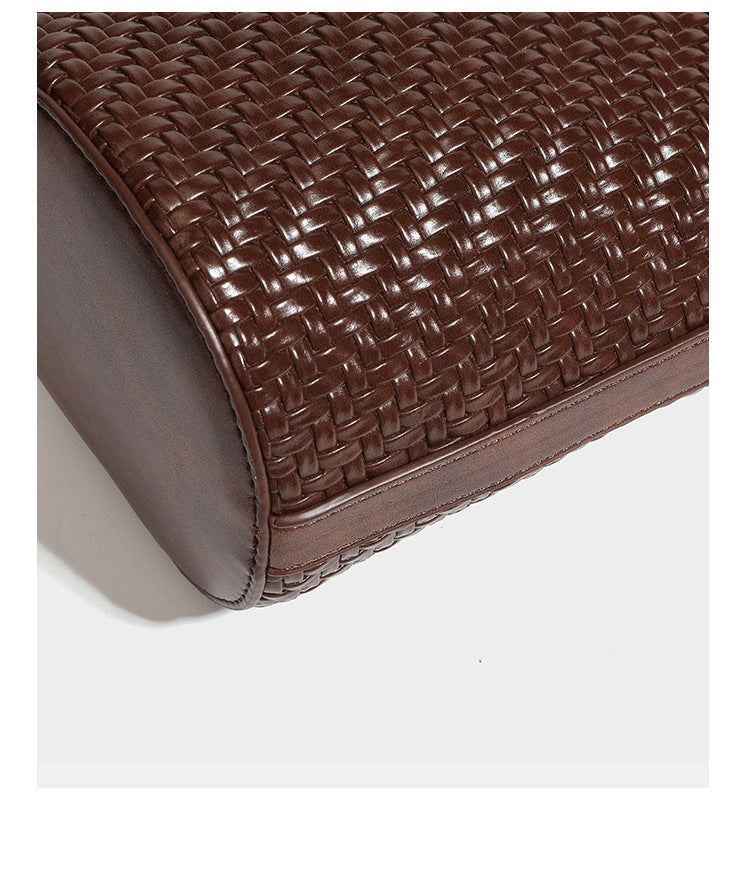 Structured woven-texture leather-look bucket bag in brown with knotted top handles, small front flap pouch, and adjustable