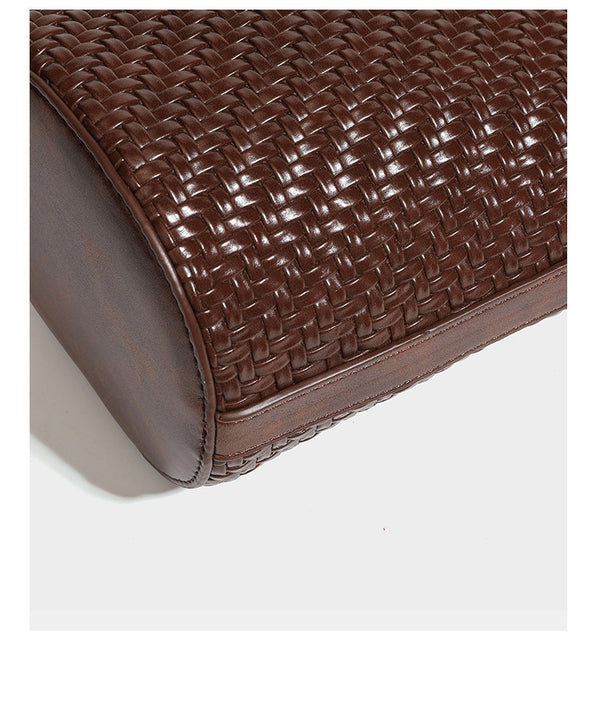 Structured woven-texture leather-look bucket bag in brown with knotted top handles, small front flap pouch, and adjustable